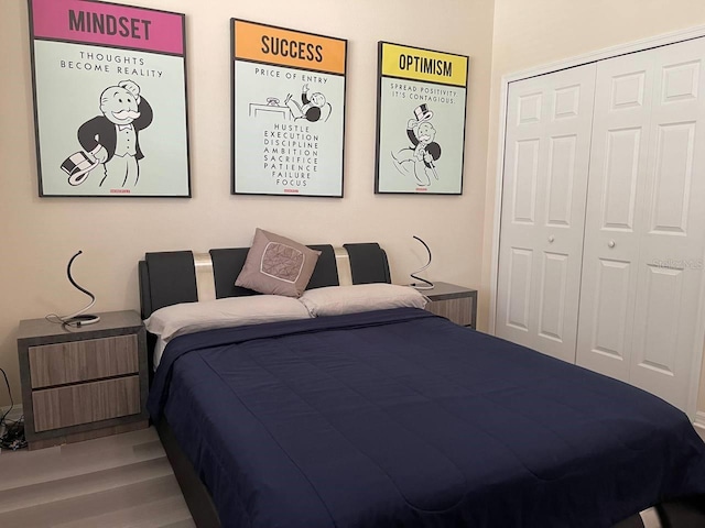 bedroom with a closet and wood finished floors