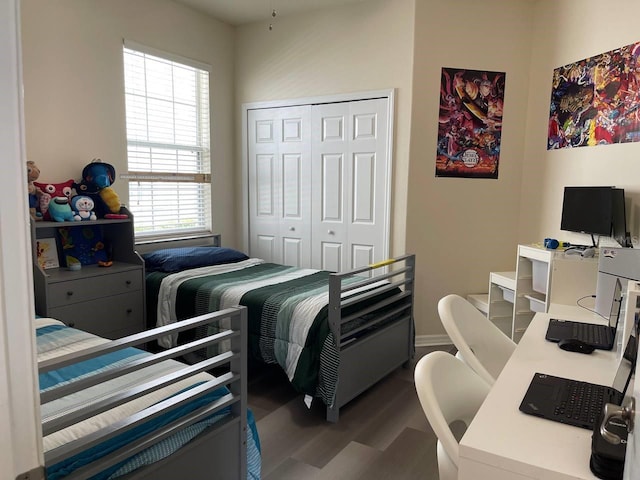 bedroom with wood finished floors and a closet