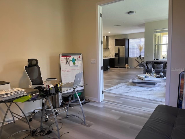 office featuring light wood-type flooring and baseboards