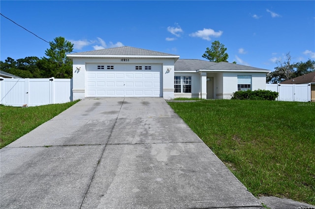 ranch-style house featuring a garage and a front lawn