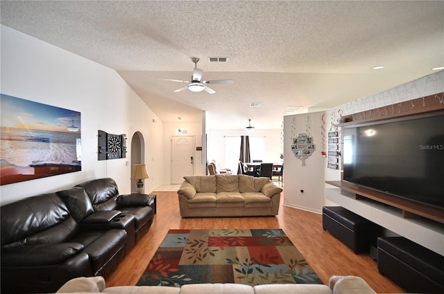 10255 Norwick St, Spring Hill, FL 34608 - living room with visible vents, vaulted ceiling, wood finished floors, a textured ceiling, and a ceiling fan