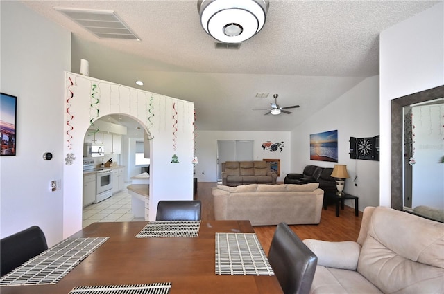 10255 Norwick St, Spring Hill, FL 34608 - dining area featuring visible vents, a textured ceiling, arched walkways, ceiling fan, and vaulted ceiling