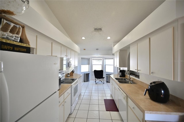 10255 Norwick St, Spring Hill, FL 34608 - kitchen with white appliances, visible vents, light tile patterned flooring, a sink, and light countertops