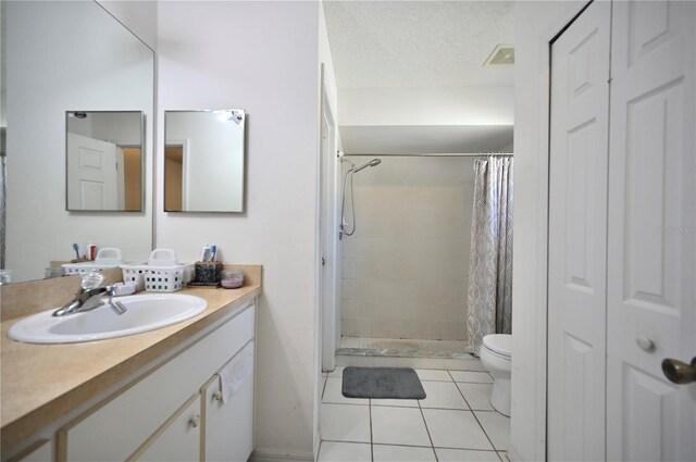 bathroom with tile patterned flooring, vanity, toilet, and a shower with shower curtain