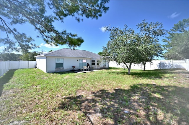 10255 Norwick St, Spring Hill, FL 34608 - rear view of house with a yard, a patio, a fenced backyard, and stucco siding