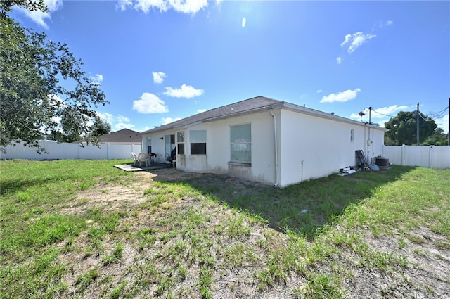 10255 Norwick St, Spring Hill, FL 34608 - back of property with a patio, cooling unit, a yard, a fenced backyard, and stucco siding