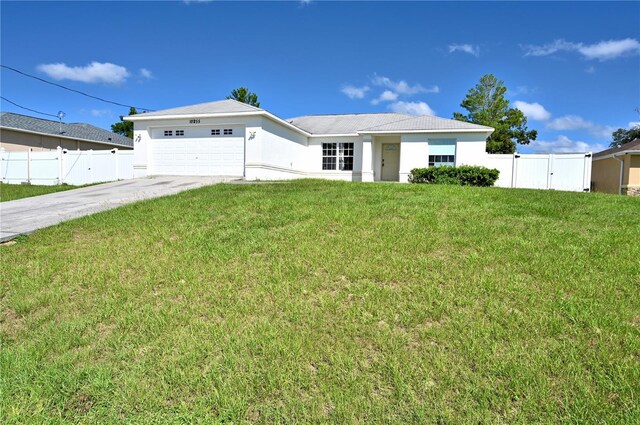 ranch-style house featuring a garage and a front yard