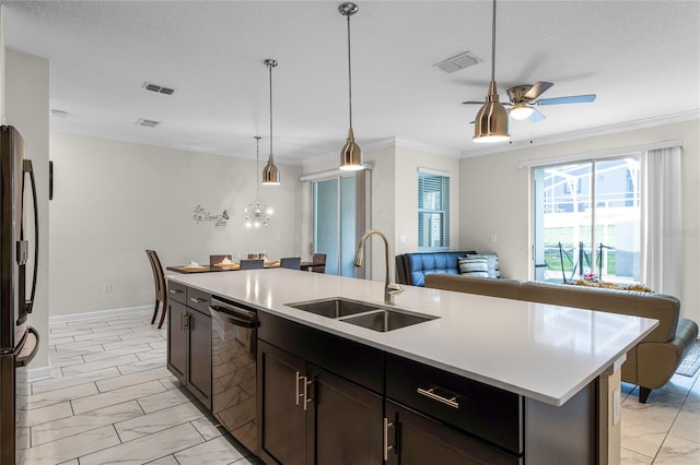 kitchen with ceiling fan with notable chandelier, a center island with sink, appliances with stainless steel finishes, hanging light fixtures, and sink