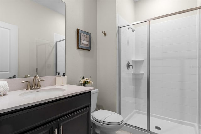 bathroom with vanity, toilet, and an enclosed shower