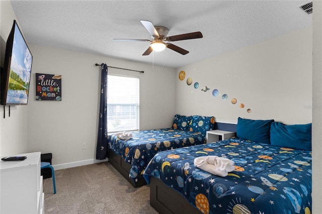 bedroom featuring a textured ceiling, ceiling fan, and carpet floors