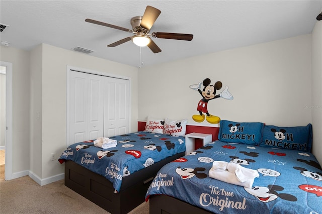 carpeted bedroom with a closet and ceiling fan