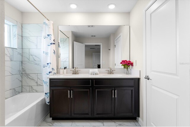 1224 Challenge Dr, Davenport, FL 33896 - bathroom featuring double vanity, a sink, marble finish floor, and shower / tub combo with curtain