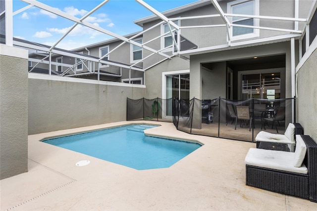 view of swimming pool with a lanai and a patio