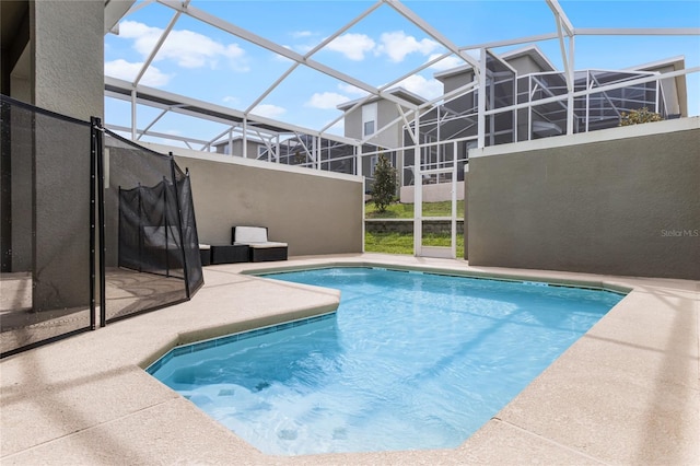 view of swimming pool with a patio and glass enclosure