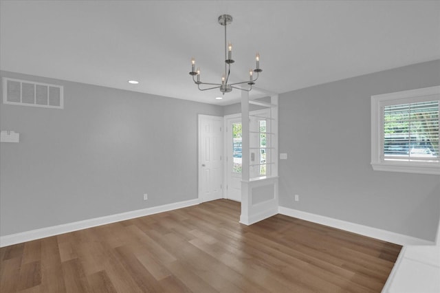 unfurnished room with visible vents, plenty of natural light, and baseboards