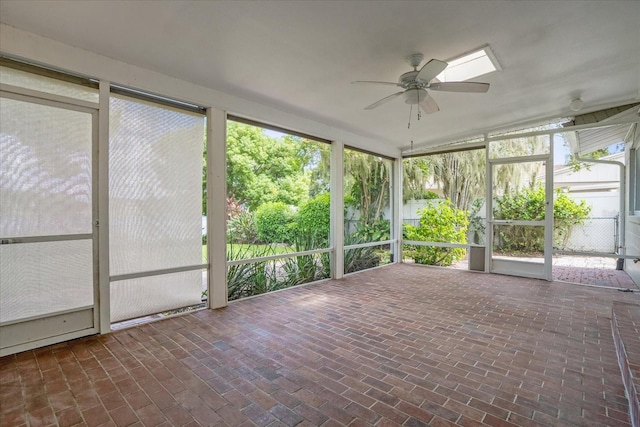 unfurnished sunroom featuring ceiling fan