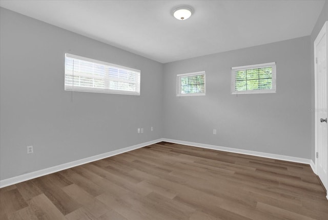 unfurnished room with wood finished floors and baseboards