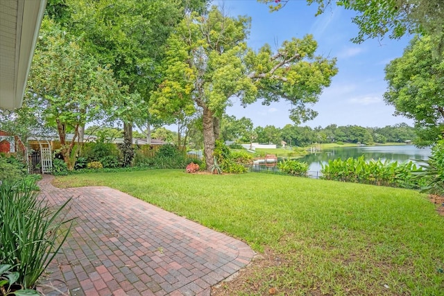 view of yard with a patio area and a water view