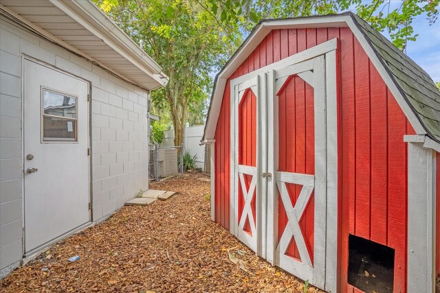 view of shed featuring fence