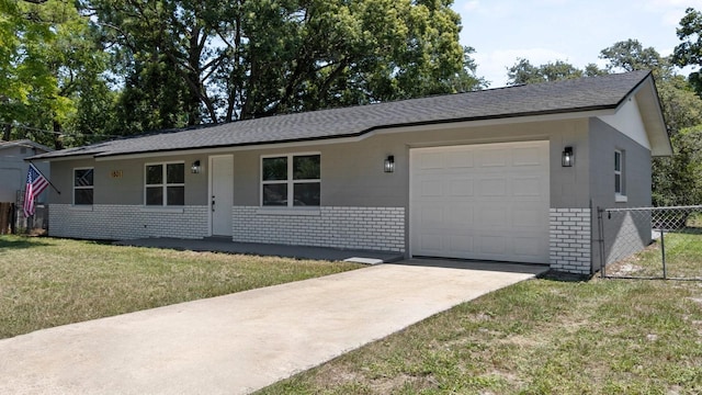 ranch-style home featuring fence, concrete driveway, a front yard, an attached garage, and brick siding