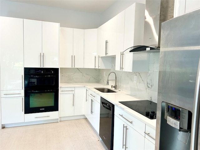 kitchen with black appliances, sink, white cabinets, and island exhaust hood