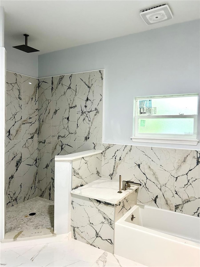 bathroom featuring tile walls and separate shower and tub