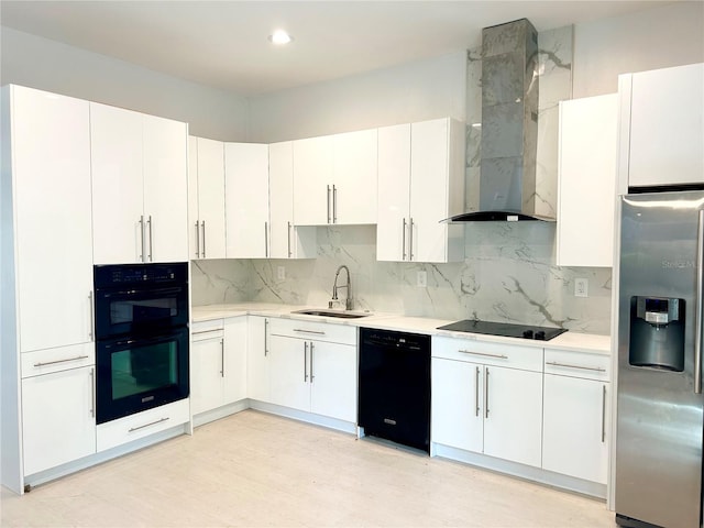 kitchen featuring white cabinetry, sink, wall chimney range hood, black appliances, and tasteful backsplash