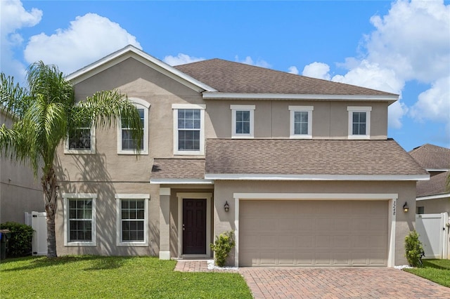 view of front facade with a garage and a front lawn