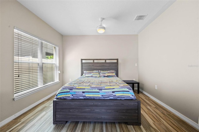 bedroom with ceiling fan and hardwood / wood-style floors