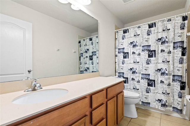 bathroom with a shower with shower curtain, vanity, toilet, and tile patterned floors