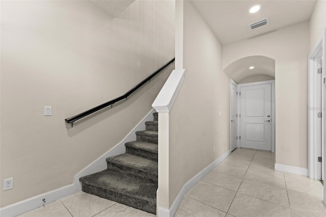 staircase with tile patterned floors