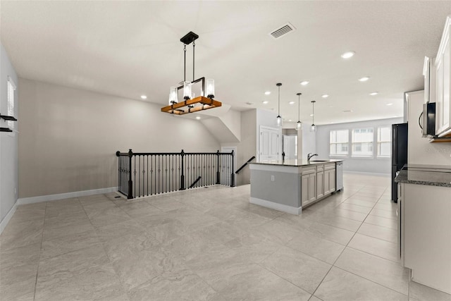 kitchen with decorative light fixtures, white cabinetry, sink, a center island with sink, and stainless steel dishwasher