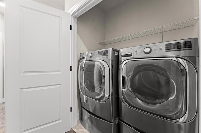 washroom featuring washer and dryer