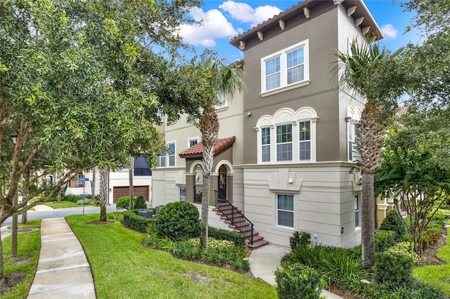 mediterranean / spanish-style house with a front yard