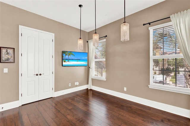 unfurnished dining area with dark hardwood / wood-style floors