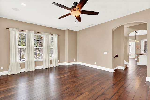 empty room with sink, ceiling fan, and dark hardwood / wood-style floors