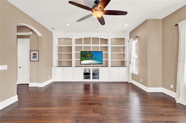 unfurnished living room featuring ceiling fan and dark hardwood / wood-style floors