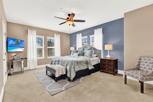 bedroom featuring light carpet and ceiling fan