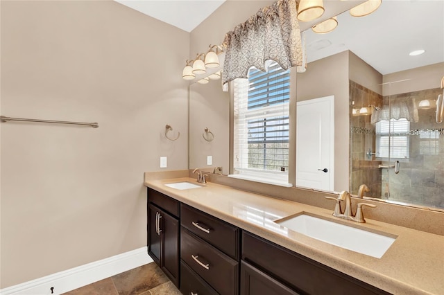 bathroom with tile patterned floors, a shower with door, and vanity