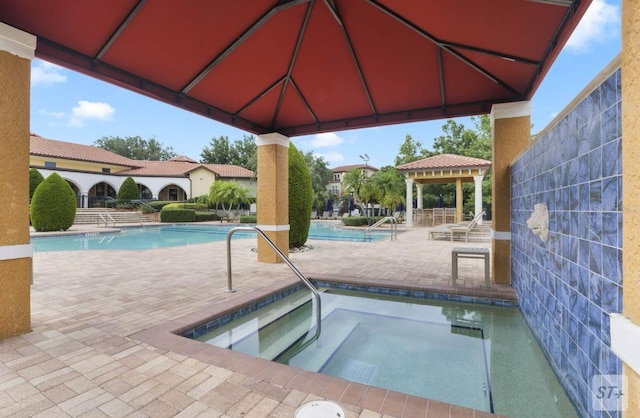 view of swimming pool featuring a patio area and a gazebo