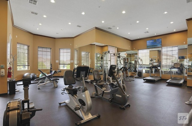 exercise room featuring crown molding