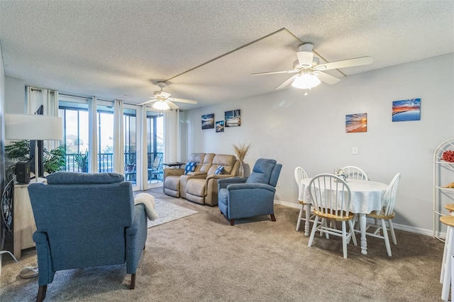 living room featuring a textured ceiling, ceiling fan, and carpet floors