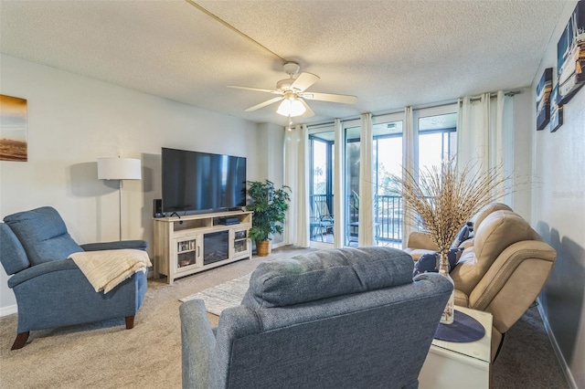 carpeted living room featuring a textured ceiling and ceiling fan