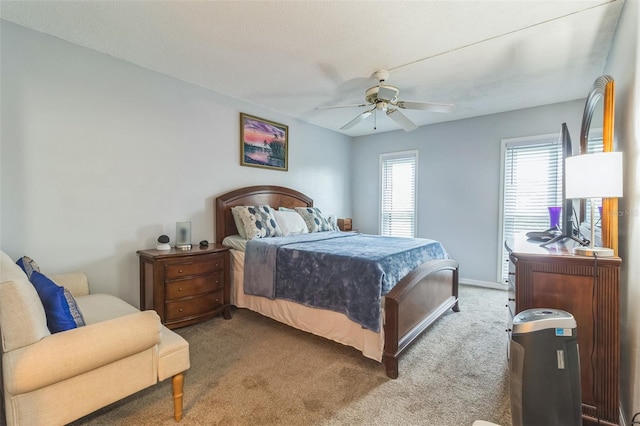 carpeted bedroom with a textured ceiling and ceiling fan