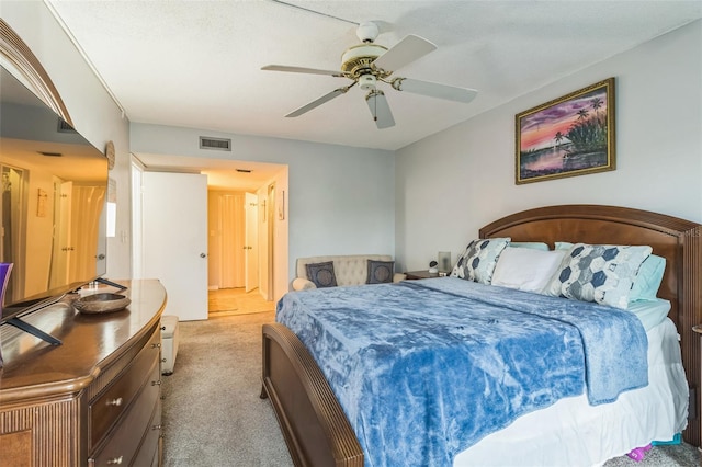 bedroom featuring light colored carpet and ceiling fan