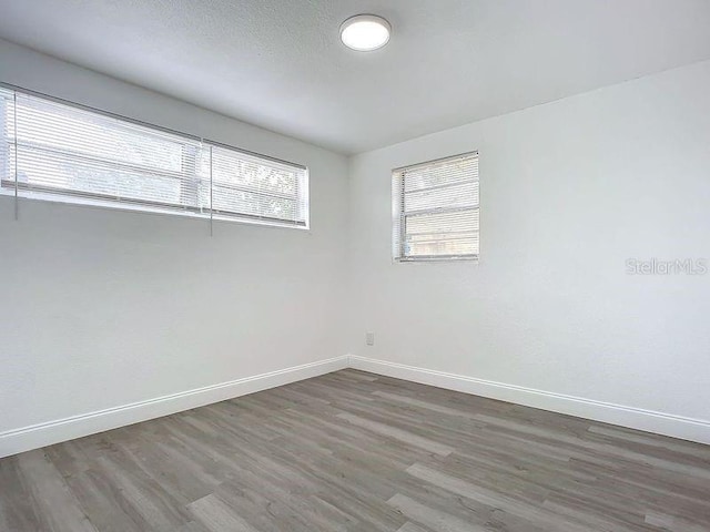 empty room featuring dark wood-type flooring and a textured ceiling