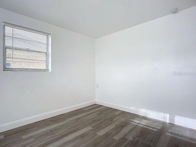 spare room featuring dark hardwood / wood-style floors