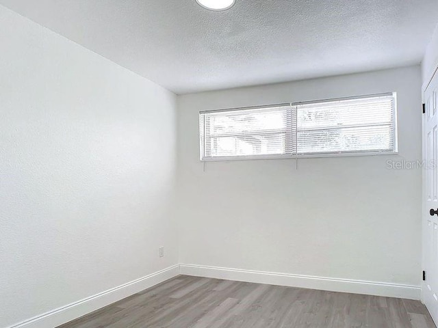 unfurnished room with hardwood / wood-style floors and a wealth of natural light