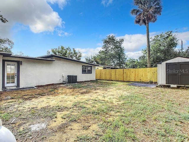 view of yard featuring cooling unit and a storage unit