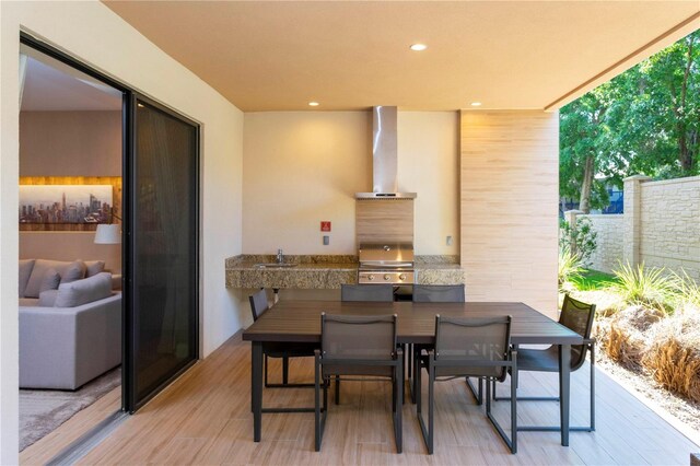 exterior space featuring grilling area and an outdoor kitchen